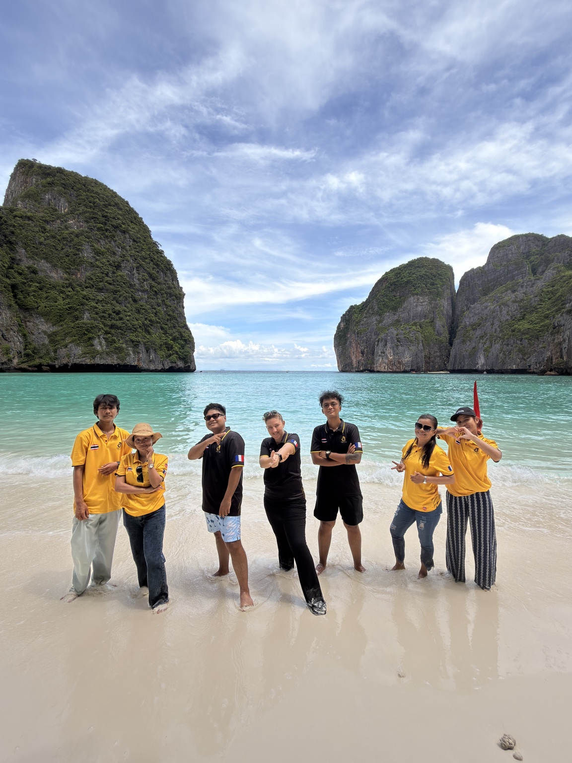 Marine and the six members of the JETTA team together on a beach in Thailand